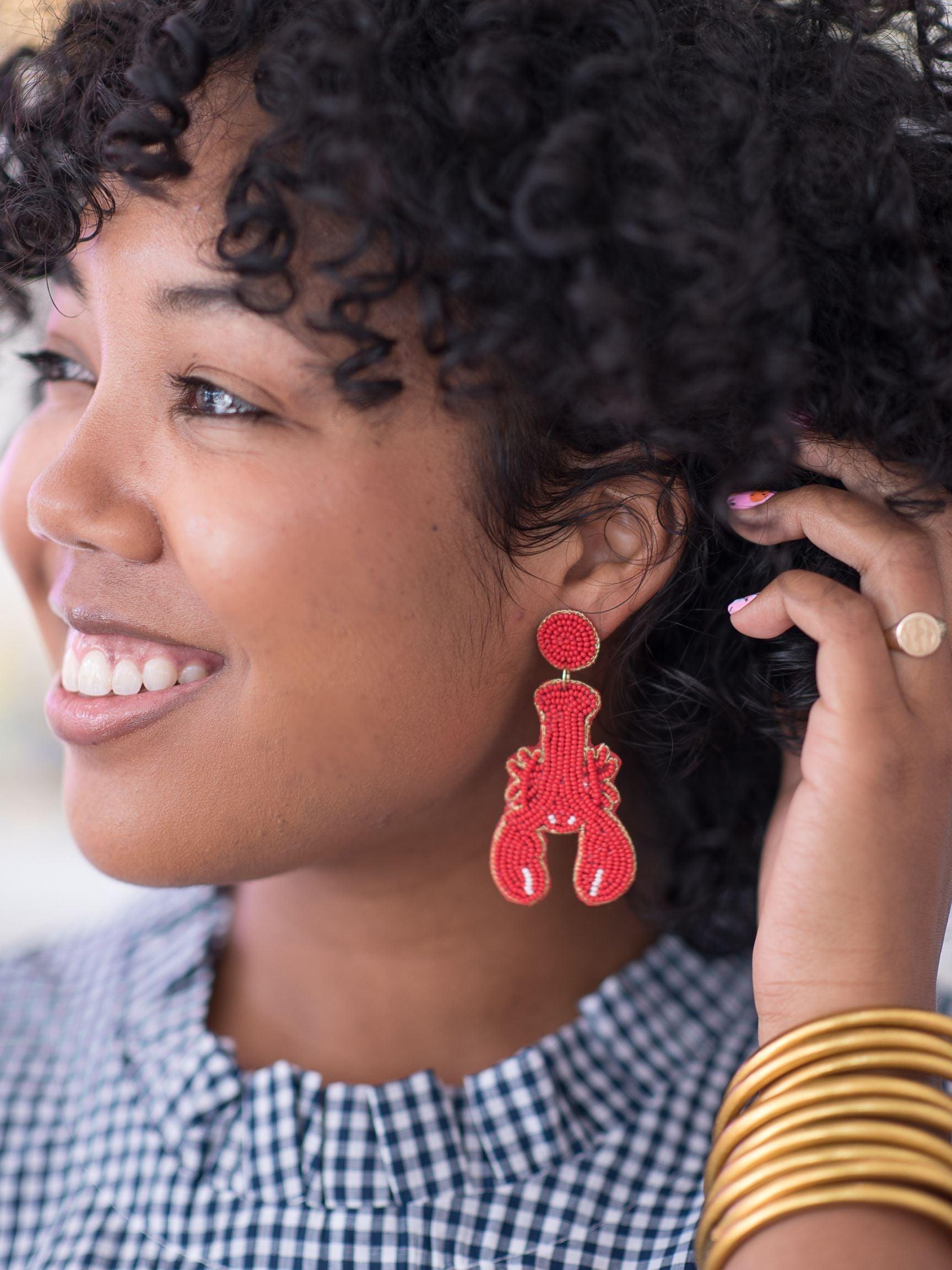 A woman wearing a lobster earring 
