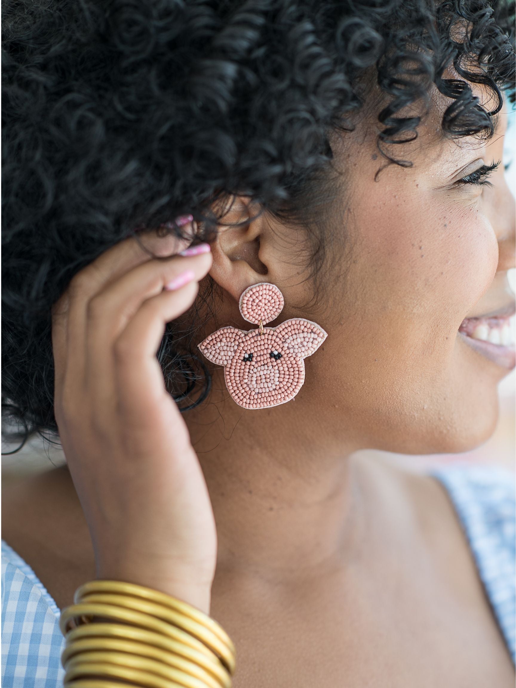 A woman wearing pink earrings
