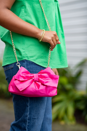 hot pink satin bow clutch with crossbody chain