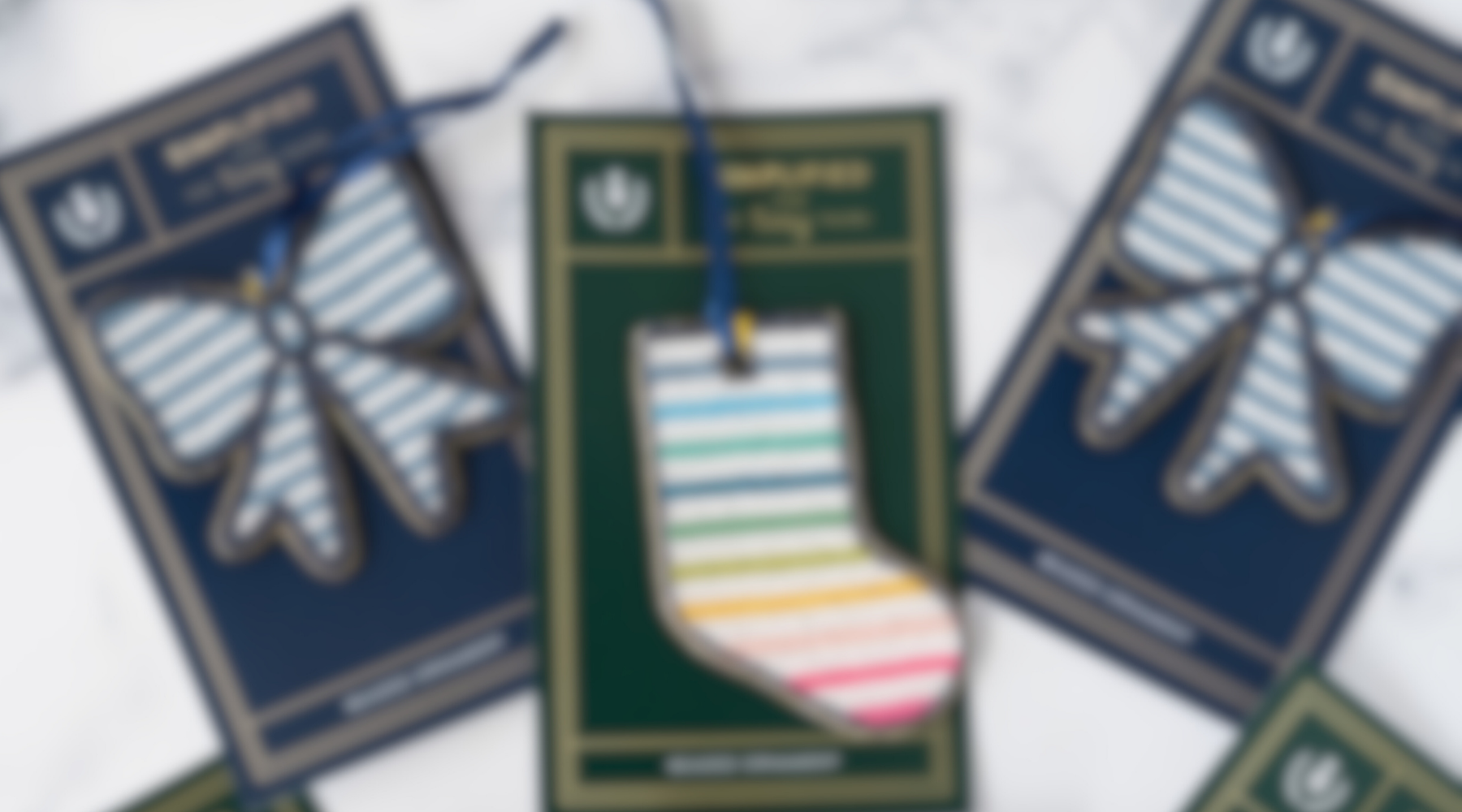 Blurred photo of blue and white striped bows on either side of a rainbow striped stocking