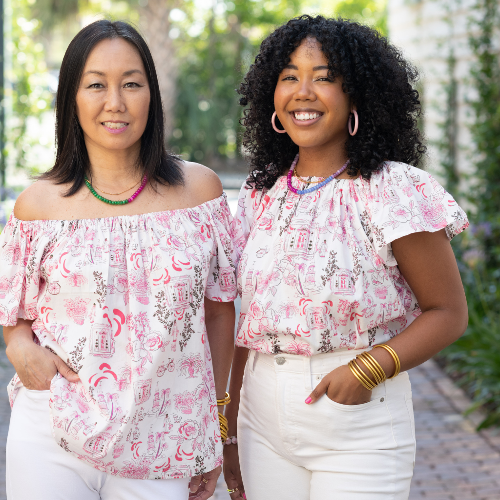 Pink charleston printed shirt off the shoulder worn by two women standing side by side