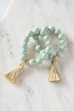 green and white chinoiserie beaded bracelet with gold tassel