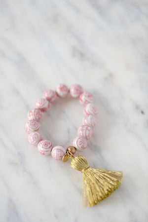 pink and white chinoiserie bead with gold tassel