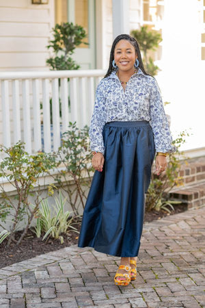 model wearing navy maxi skirt with pink plaid top